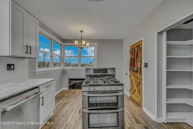a kitchen with stainless steel appliances a stove and a refrigerator