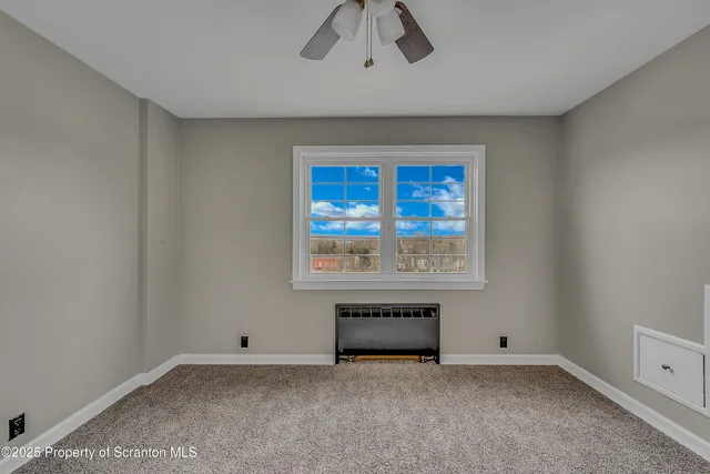 a view of empty room with fireplace