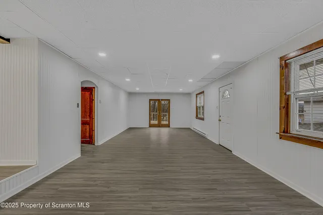 an empty room with wooden floor and closet