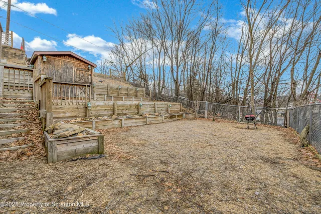 a backyard of a house with oven and outdoor seating
