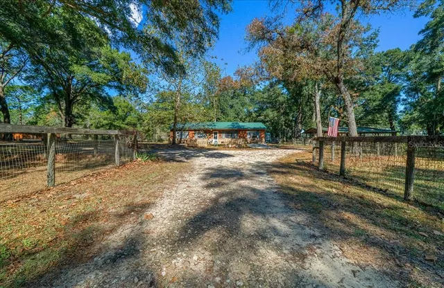a kitchen with stainless steel appliances granite countertop a stove top oven a refrigerator and a dining table view