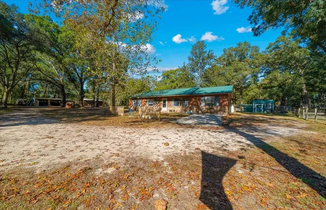 a bedroom with a bed and a flat tv screen on dresser