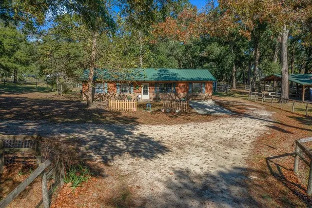 a view of a yard with large trees