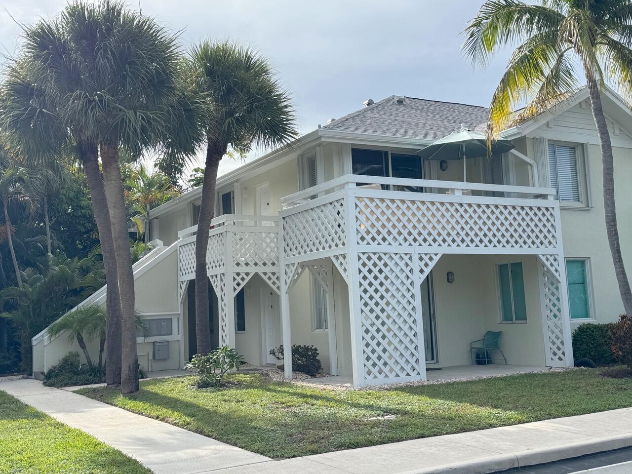 353 Highway 1, Unit C7 Jupiter, FL 33477 - Photo 14 of 25 a front view of a house with a yard