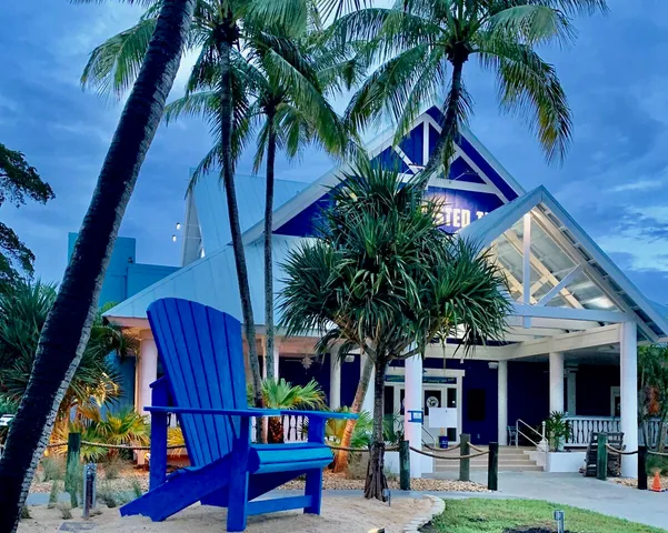 a palm tree sitting in front of a building