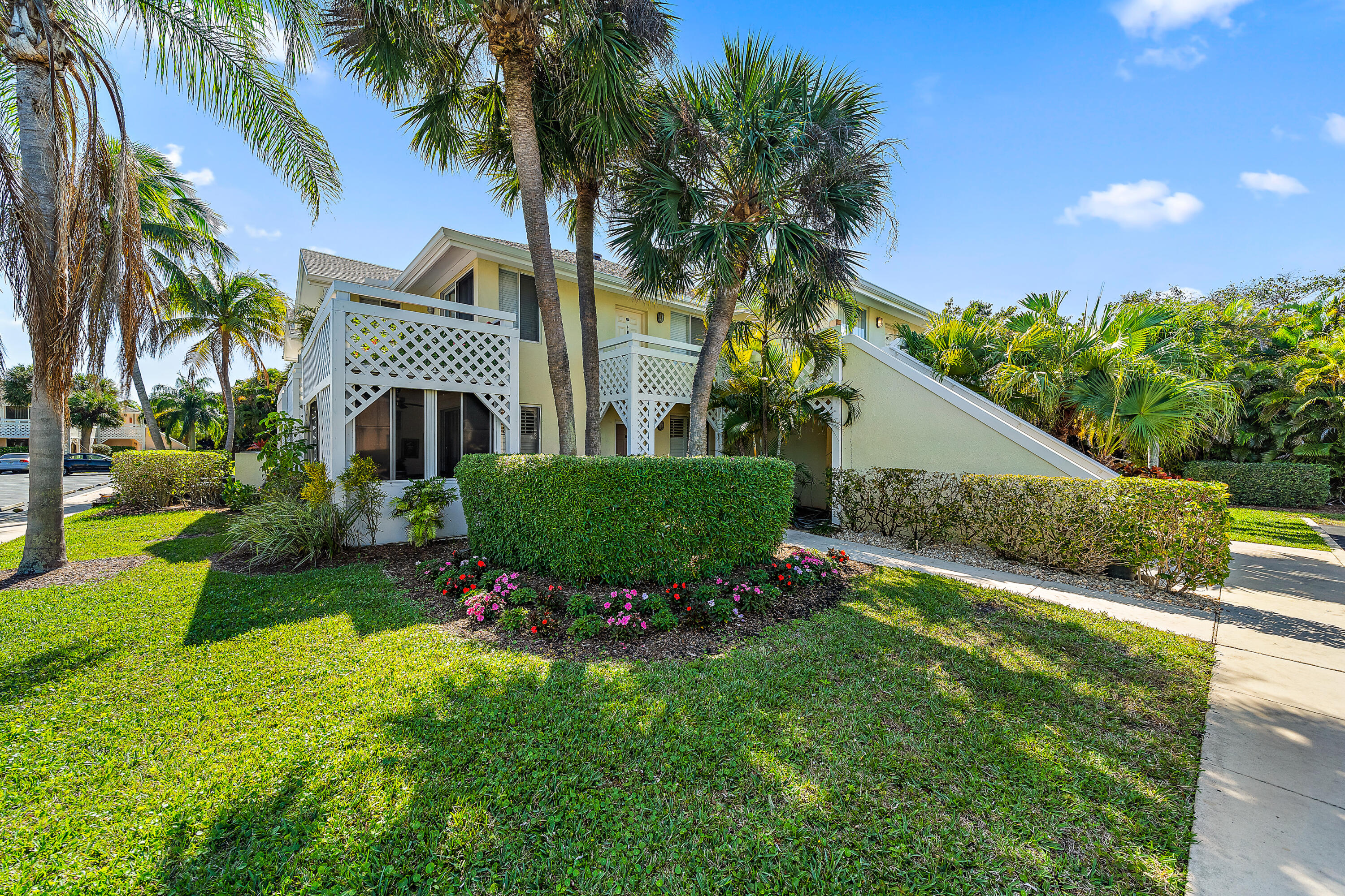 353 Highway 1, Unit C7 Jupiter, FL 33477 - Photo 2 of 25 a front view of a house with a yard
