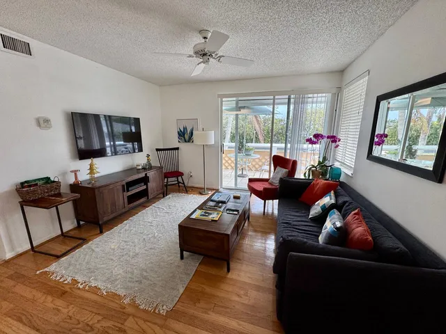 a living room with furniture fireplace and a flat screen tv