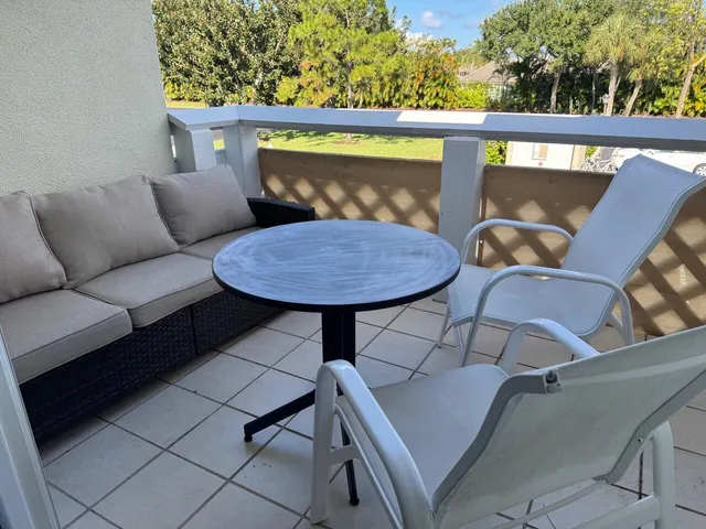 a balcony view with a seating space