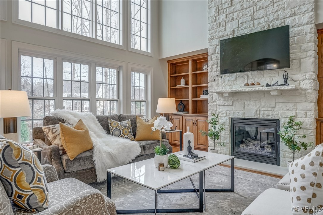 3412 Handley Road Midlothian, VA 23113 - Photo 11 of 50 a living room with furniture a flat screen tv and a fireplace