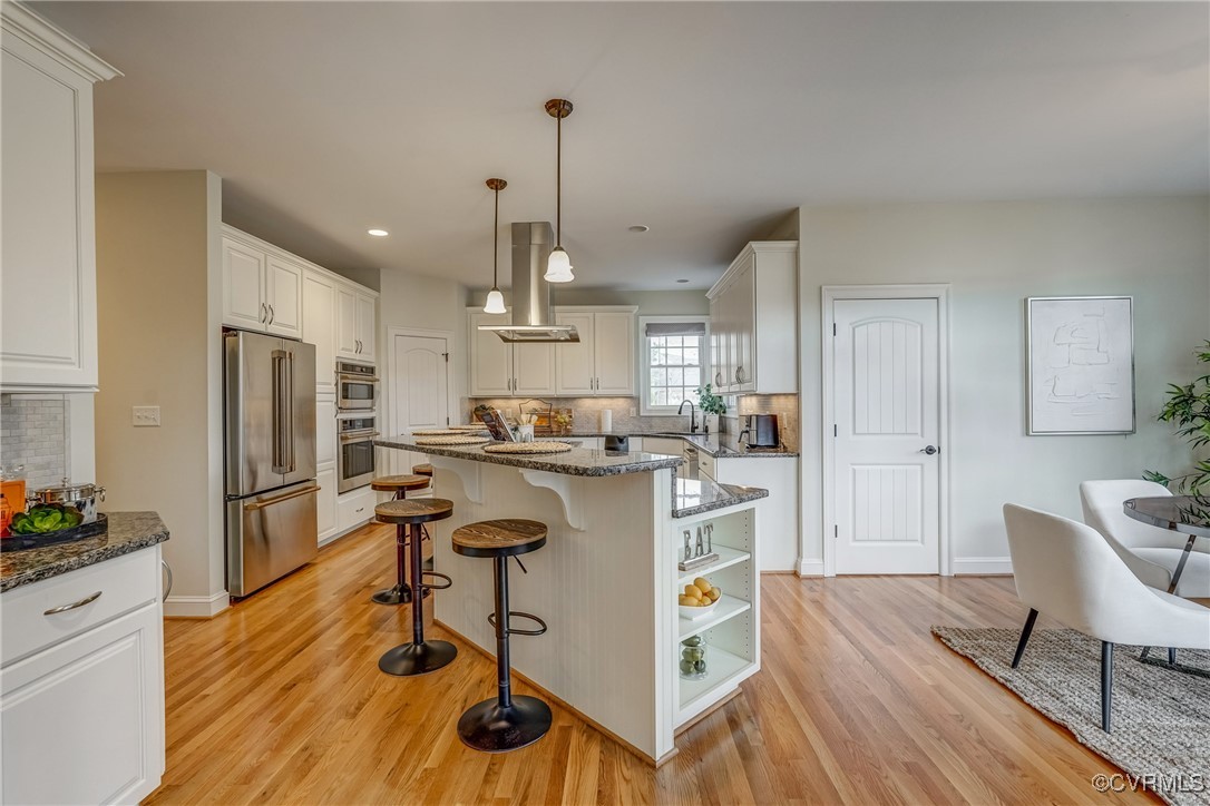 3412 Handley Road Midlothian, VA 23113 - Photo 19 of 50 a kitchen with kitchen island white cabinets and stainless steel appliances