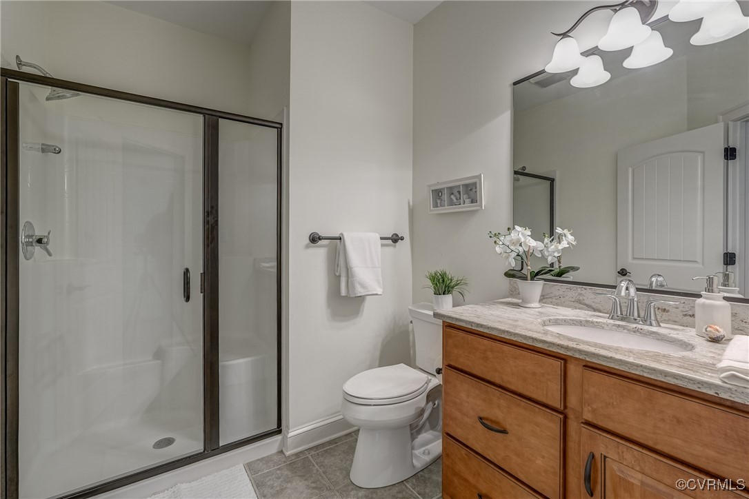 3412 Handley Road Midlothian, VA 23113 - Photo 34 of 50 a bathroom with a granite countertop sink toilet a mirror and shower