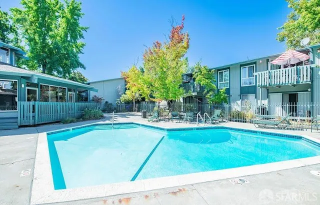 a view of a house with swimming pool and sitting area