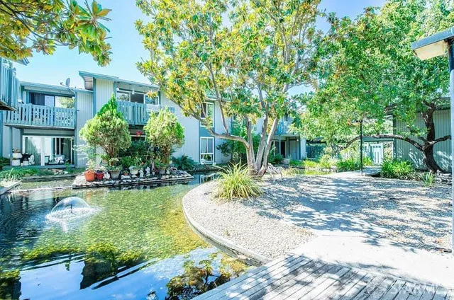 a view of a house with swimming pool and a garden