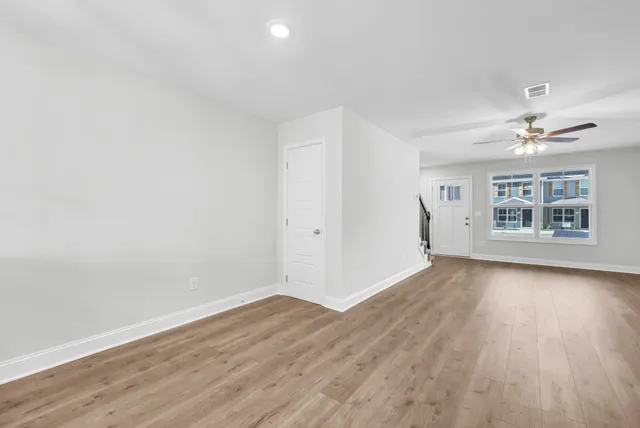 wooden floor in an empty room with a window