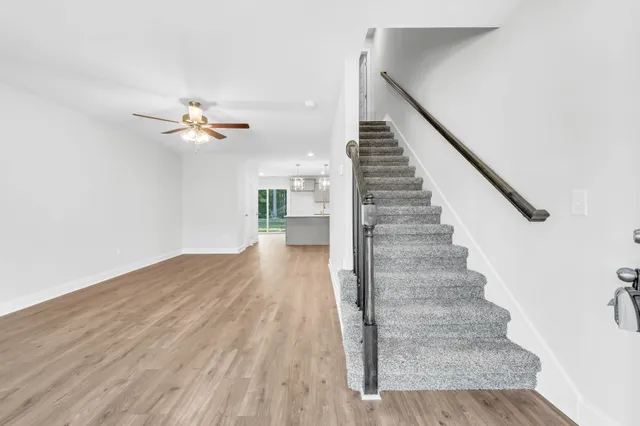 a view of entryway and hall with wooden floor