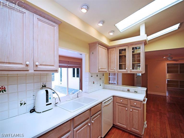 916 Beach Road Sanibel, FL 33957 - Photo 3 of 14 a kitchen with stainless steel appliances sink refrigerator and cabinets