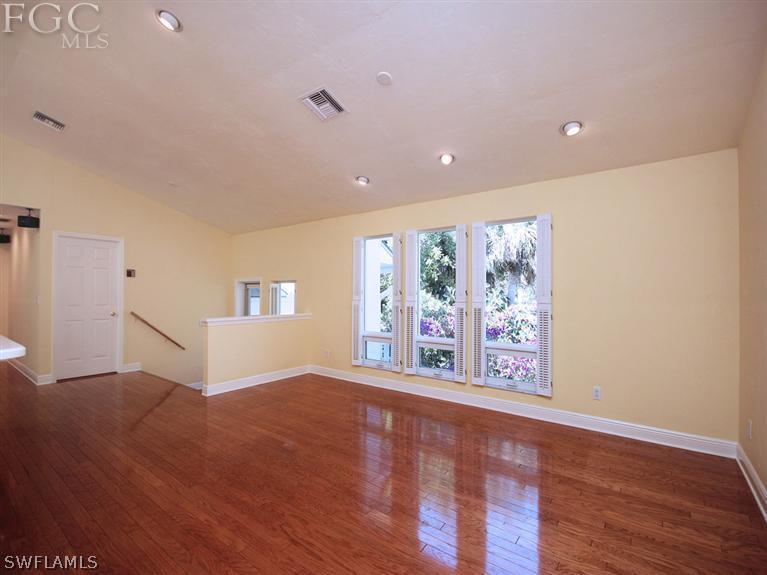 916 Beach Road Sanibel, FL 33957 - Photo 6 of 14 a view of an empty room with a window and wooden floor