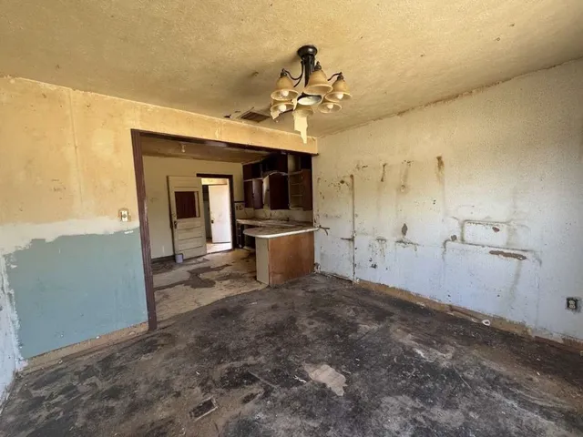 a view of a kitchen with a sink and a refrigerator