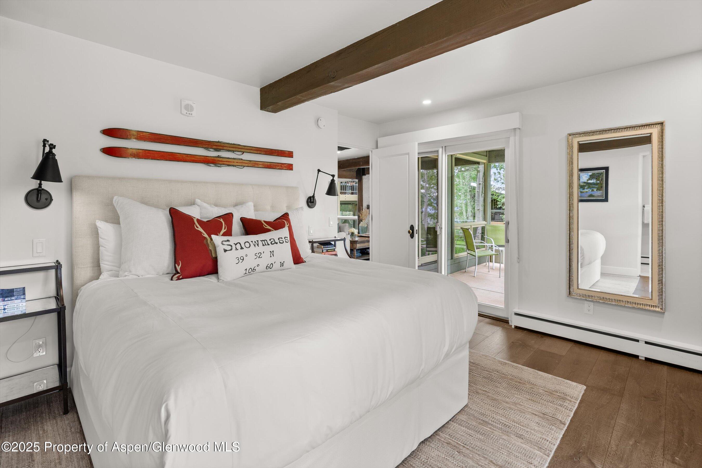 855 Carriage Way, Unit 103 Snowmass Village, CO 81615 - Photo 11 of 26 a bedroom with a large bed and a large window