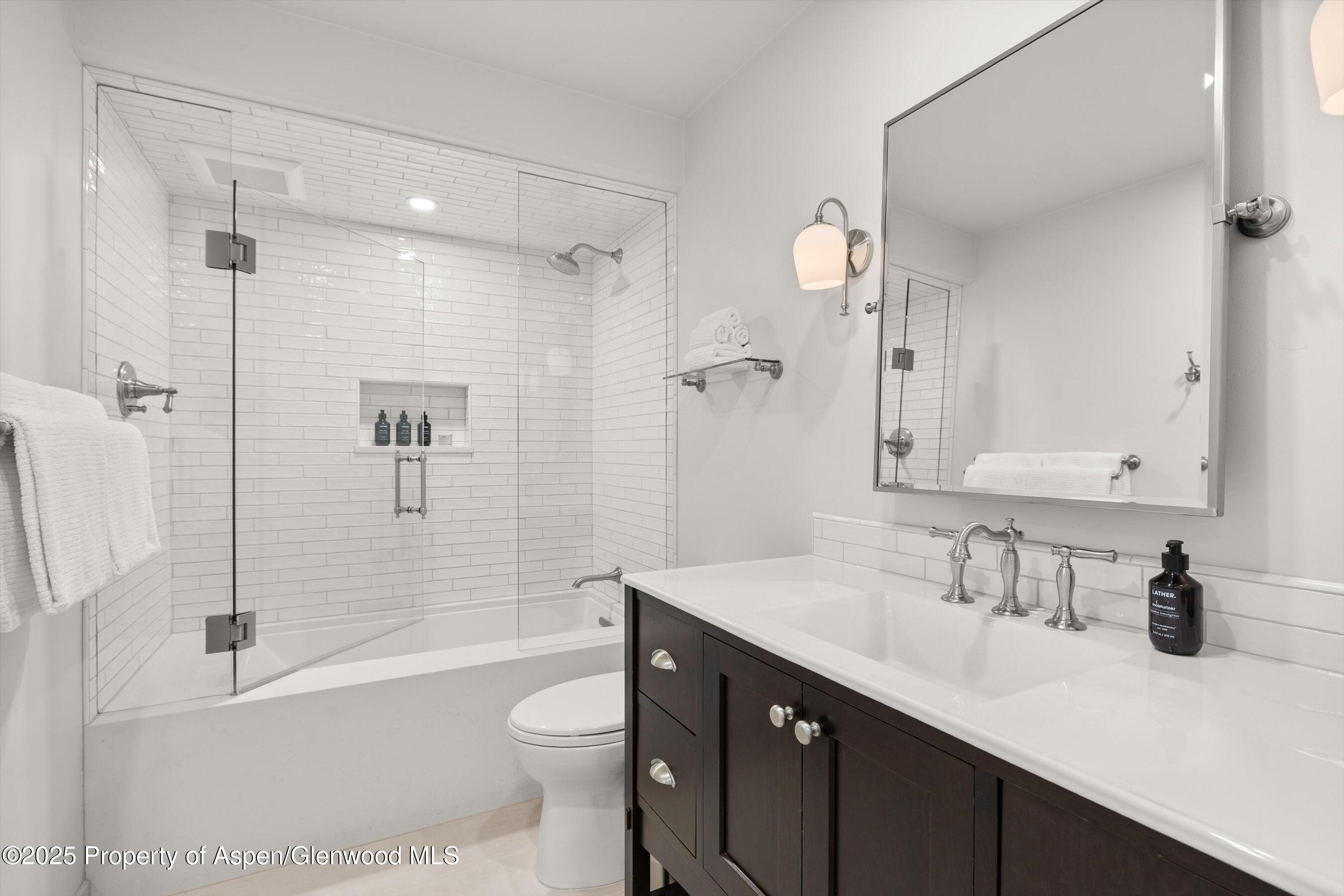 855 Carriage Way, Unit 103 Snowmass Village, CO 81615 - Photo 13 of 26 a bathroom with a sink a toilet and shower