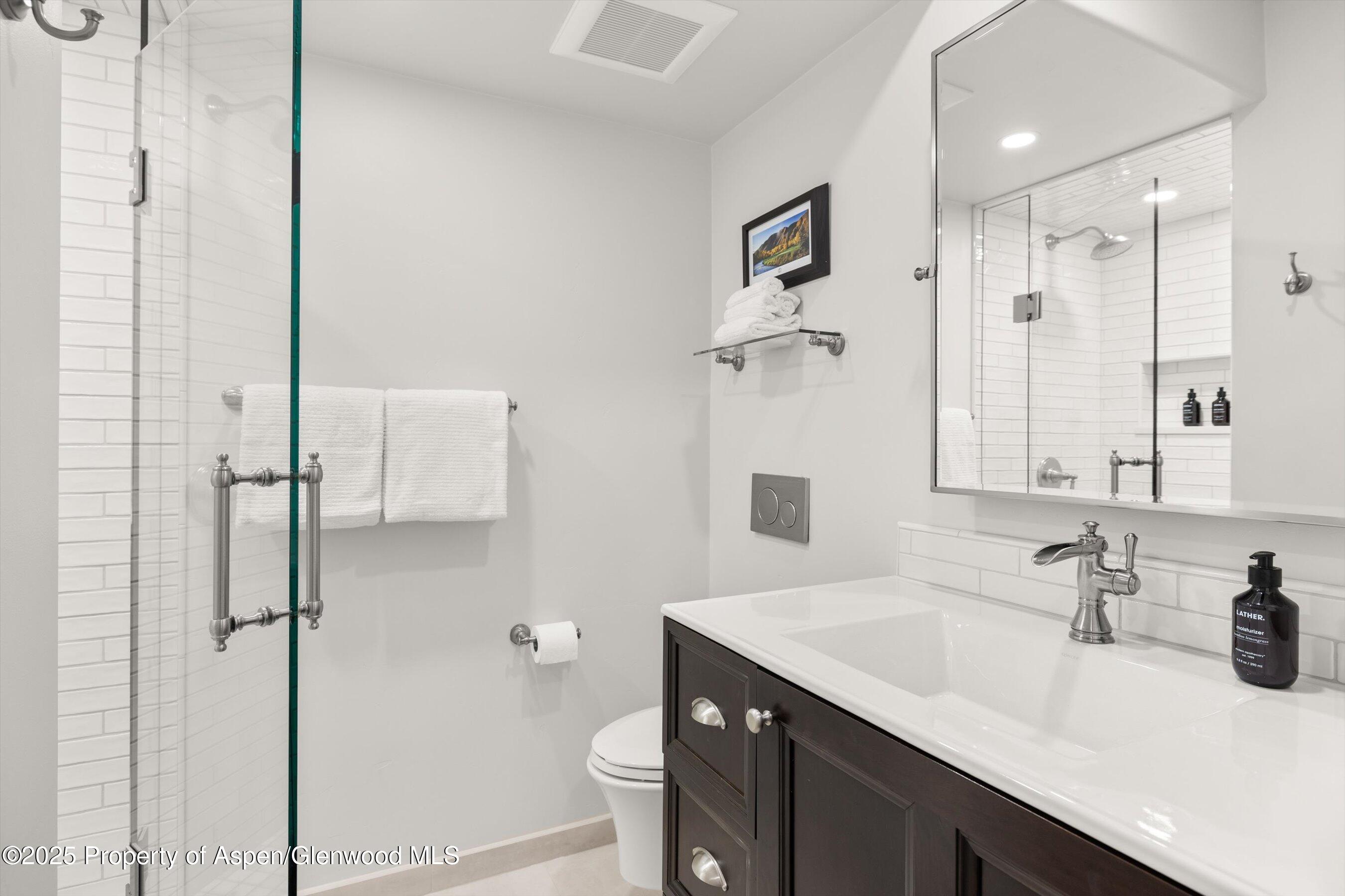 855 Carriage Way, Unit 103 Snowmass Village, CO 81615 - Photo 15 of 26 a bathroom with a sink and a mirror