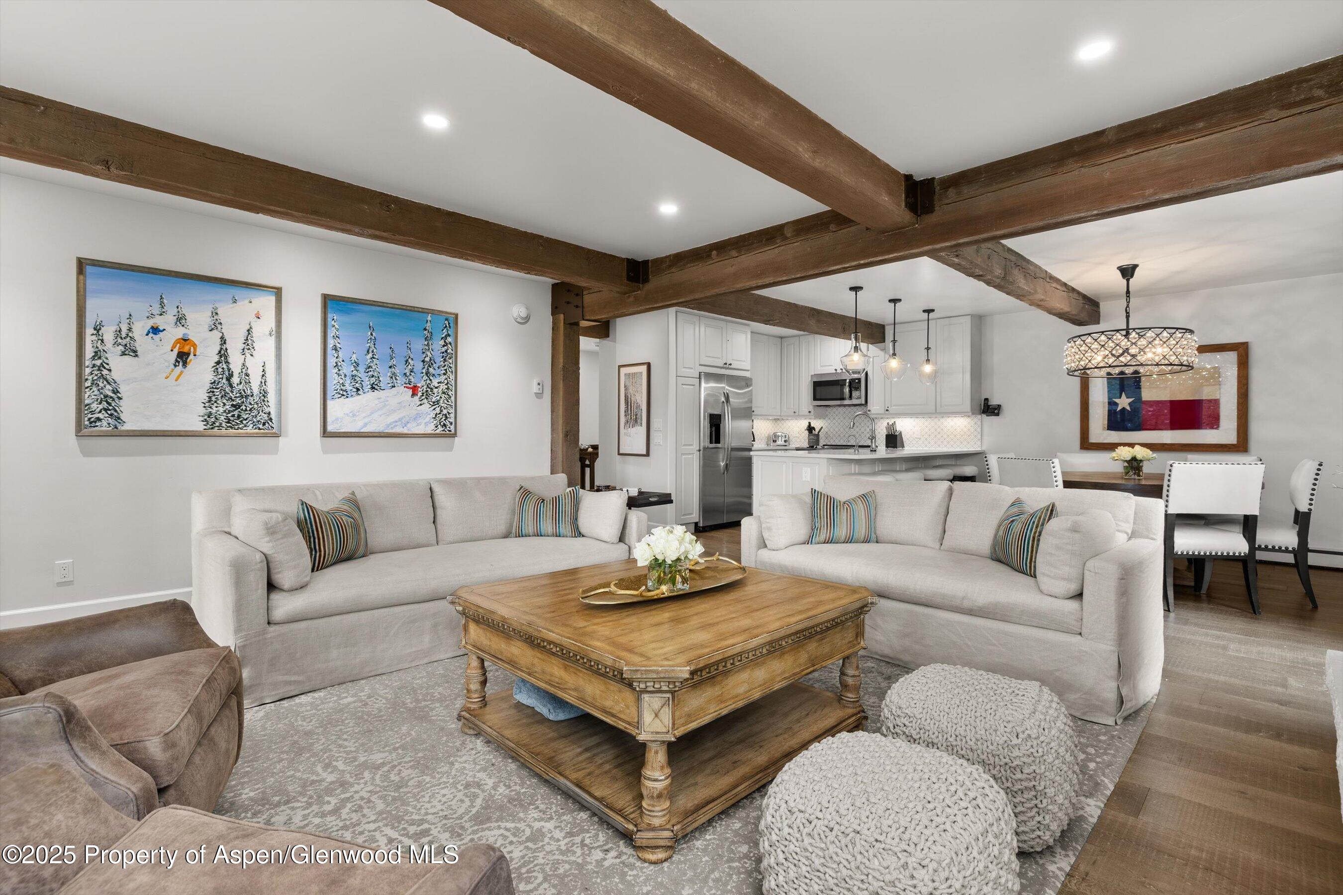 855 Carriage Way, Unit 103 Snowmass Village, CO 81615 - Photo 3 of 26 a living room with furniture and a table