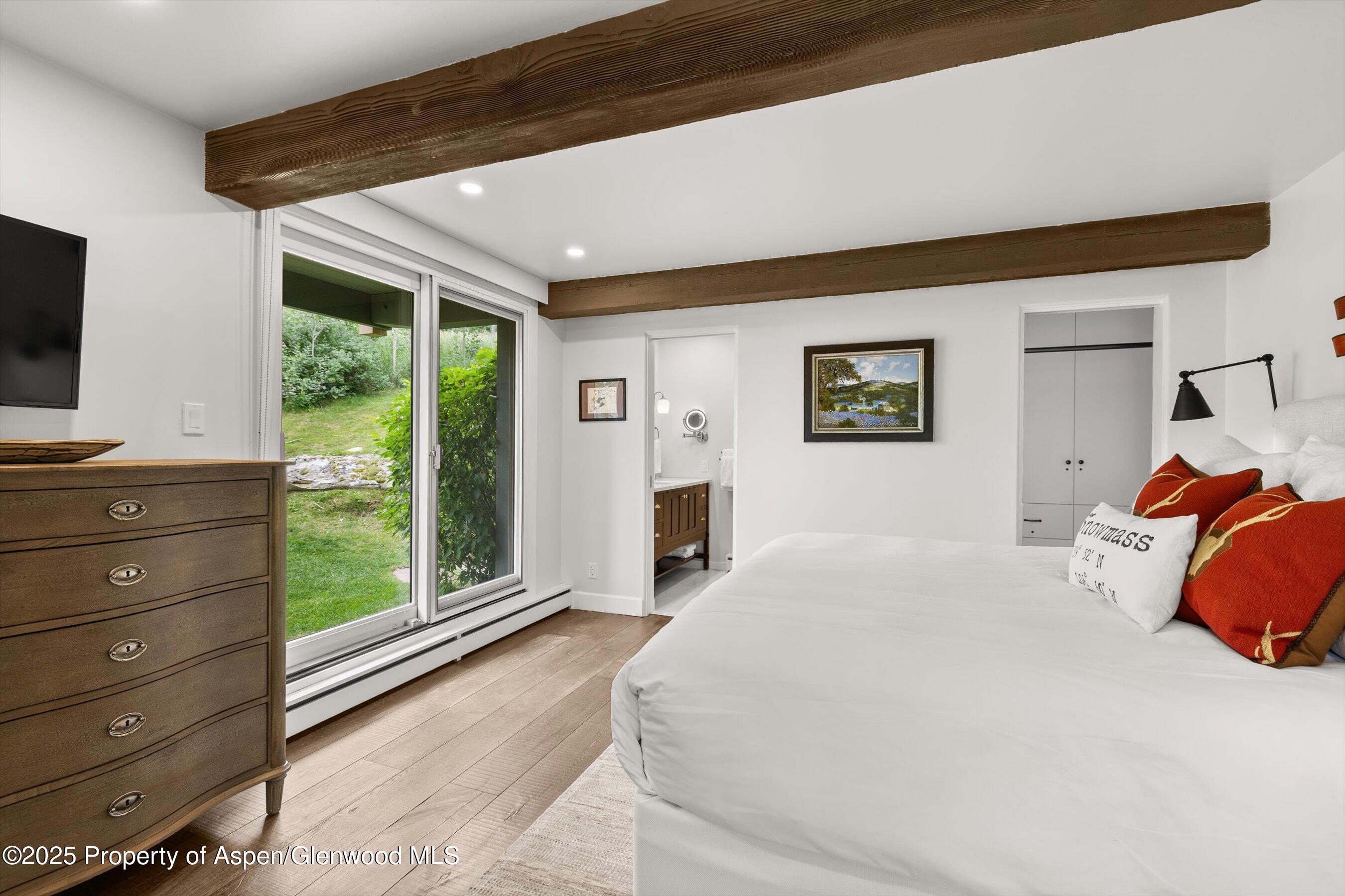 855 Carriage Way, Unit 103 Snowmass Village, CO 81615 - Photo 8 of 26 a bedroom with a bed and large window