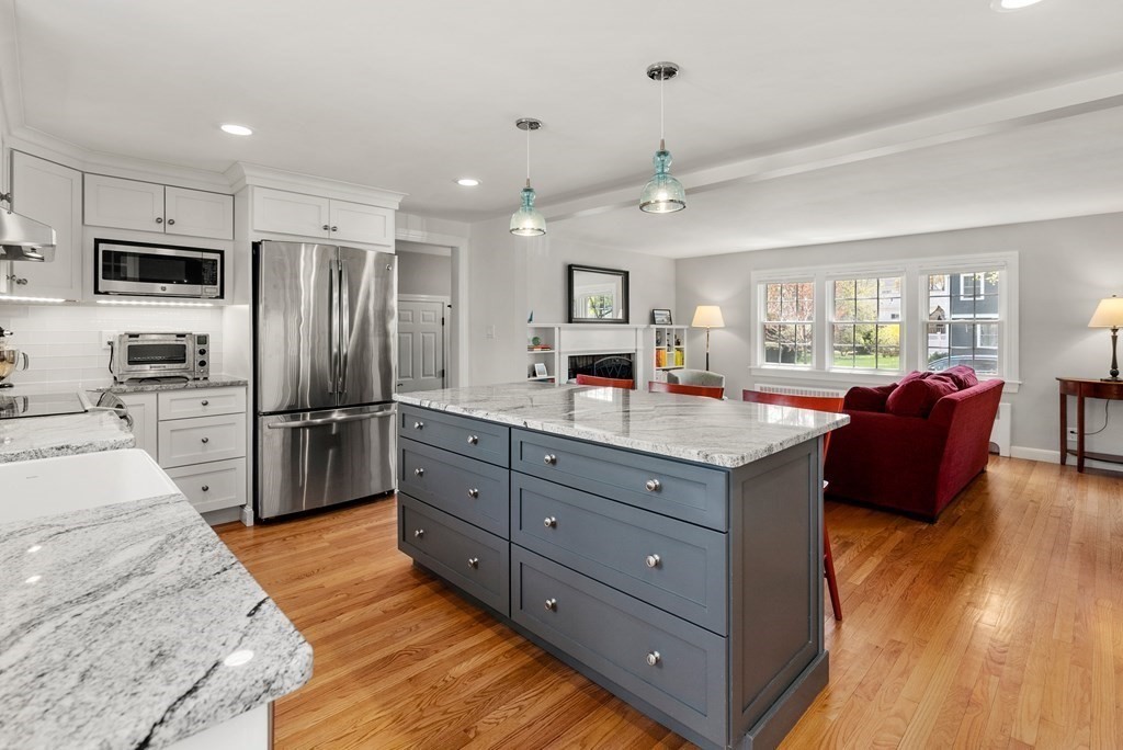 26 Cherokee Road Arlington, MA 02474 - Photo 7 of 40 a kitchen with stainless steel appliances granite countertop a refrigerator a stove top oven and sink