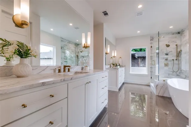 a spacious bathroom with a double vanity sink a large mirror and a shower