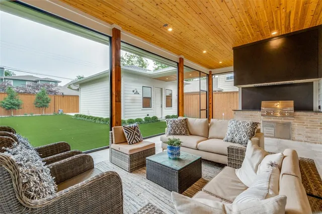 a outdoor living space with furniture potted plant and a black gate