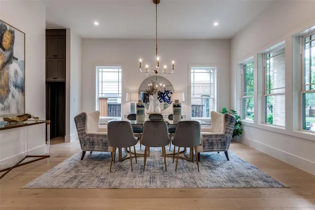 a view of a dining room with furniture a chandelier and wooden floor
