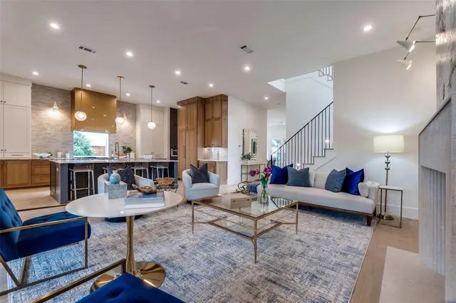 a living room with furniture and kitchen view