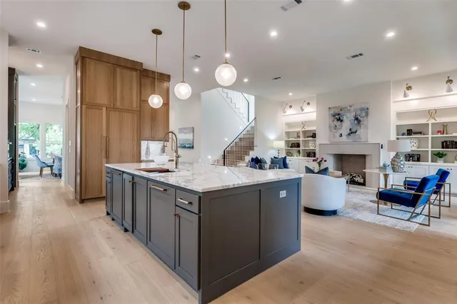 a large kitchen with kitchen island a large island a sink a stove and a refrigerator