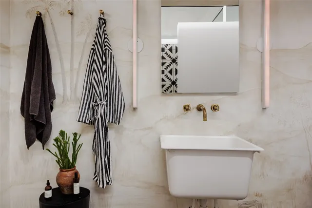 a bedroom with a bed and a table with the kitchen view