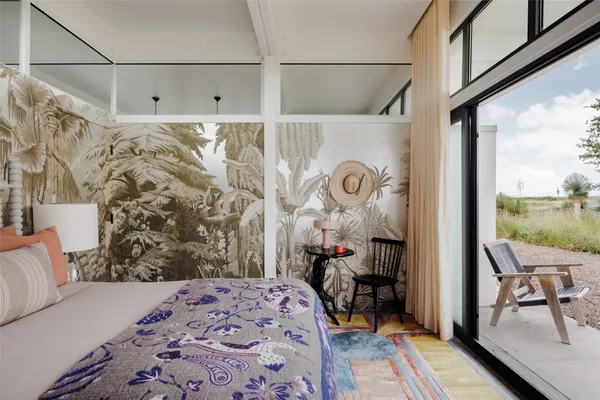 a bedroom with furniture and a window