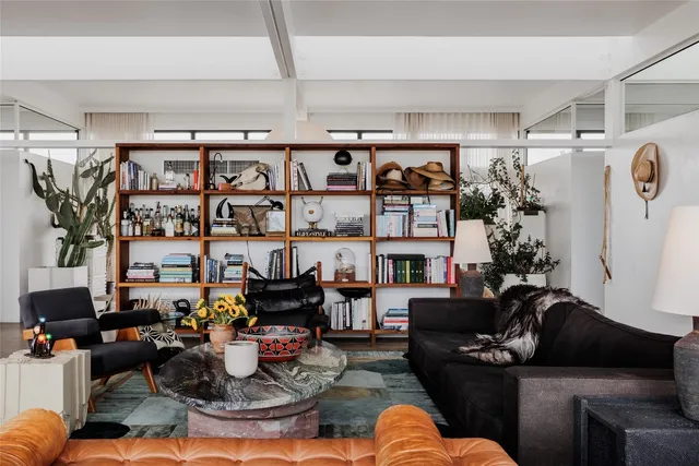 a kitchen with a stove a sink and a large window