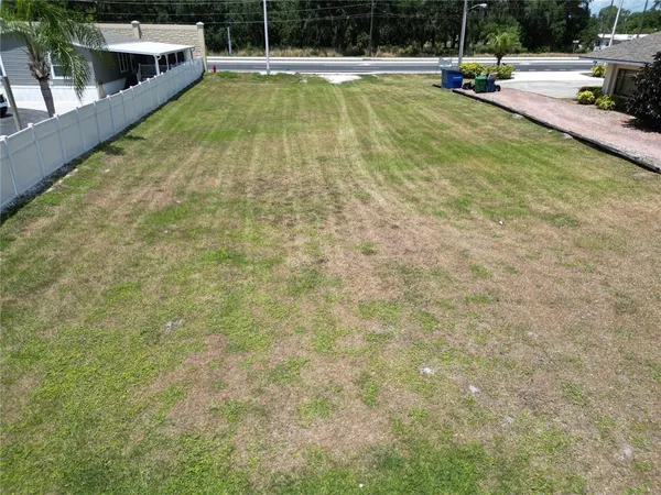 a view of a swimming pool with a yard