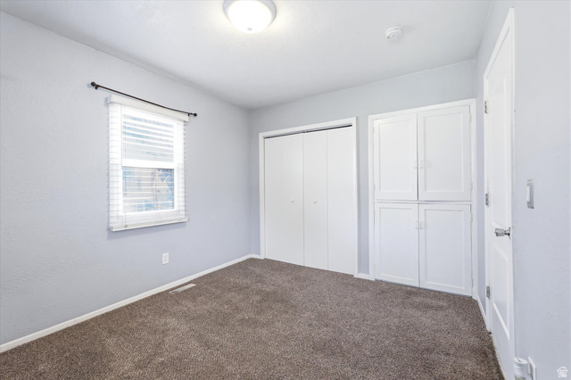 676 South 500 West Provo, UT 84601 - Photo 13 of 29 Unfurnished bedroom with dark colored carpet and a closet