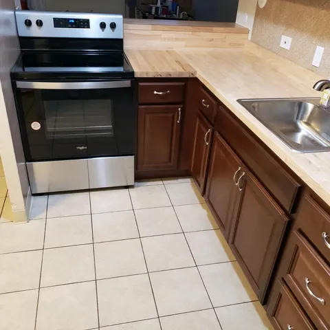 a stove top oven sitting inside of a kitchen