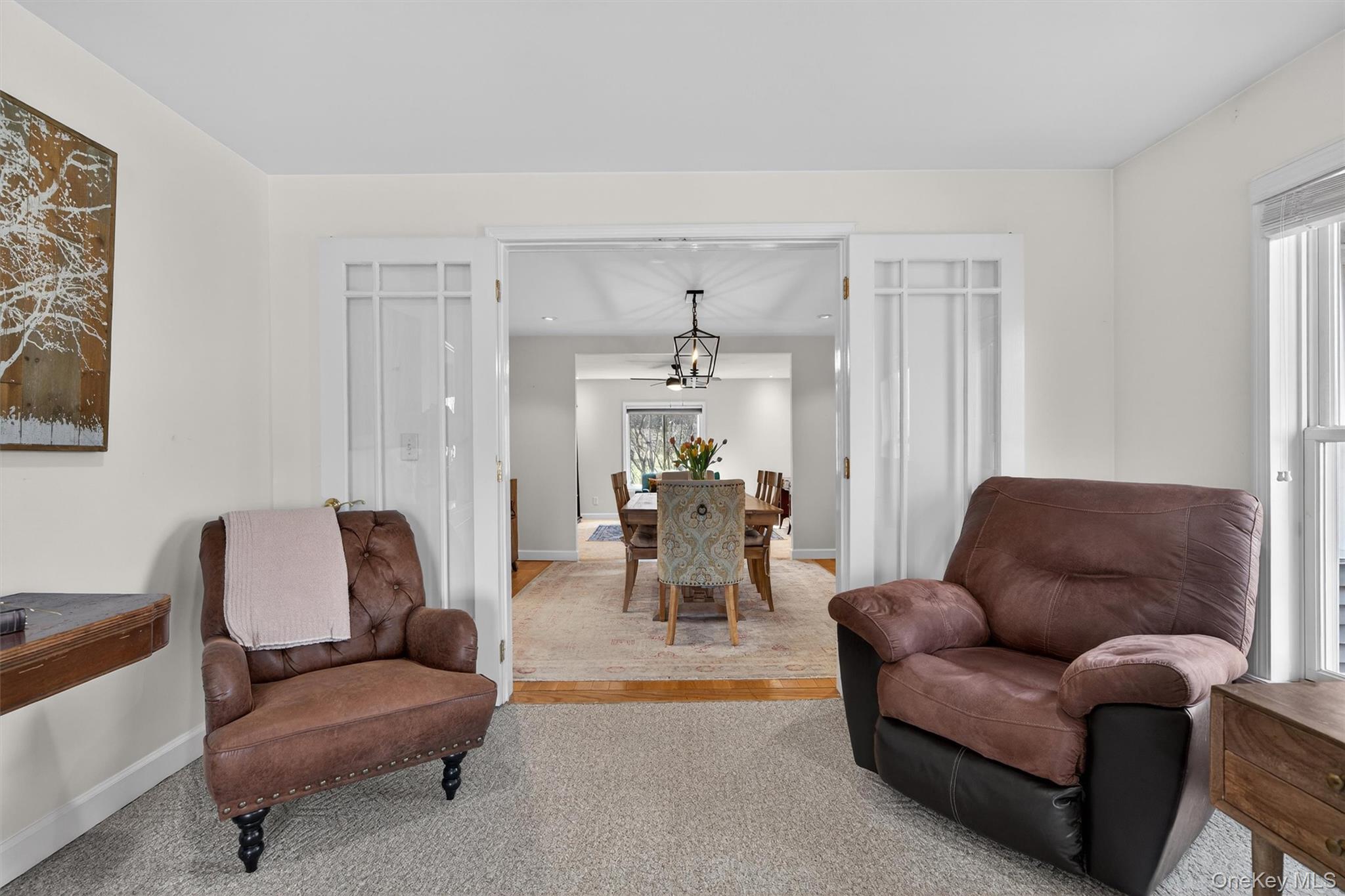 729 Mullock Road Port Jervis, NY 12771 - Photo 12 of 50 a living room with furniture and a chandelier