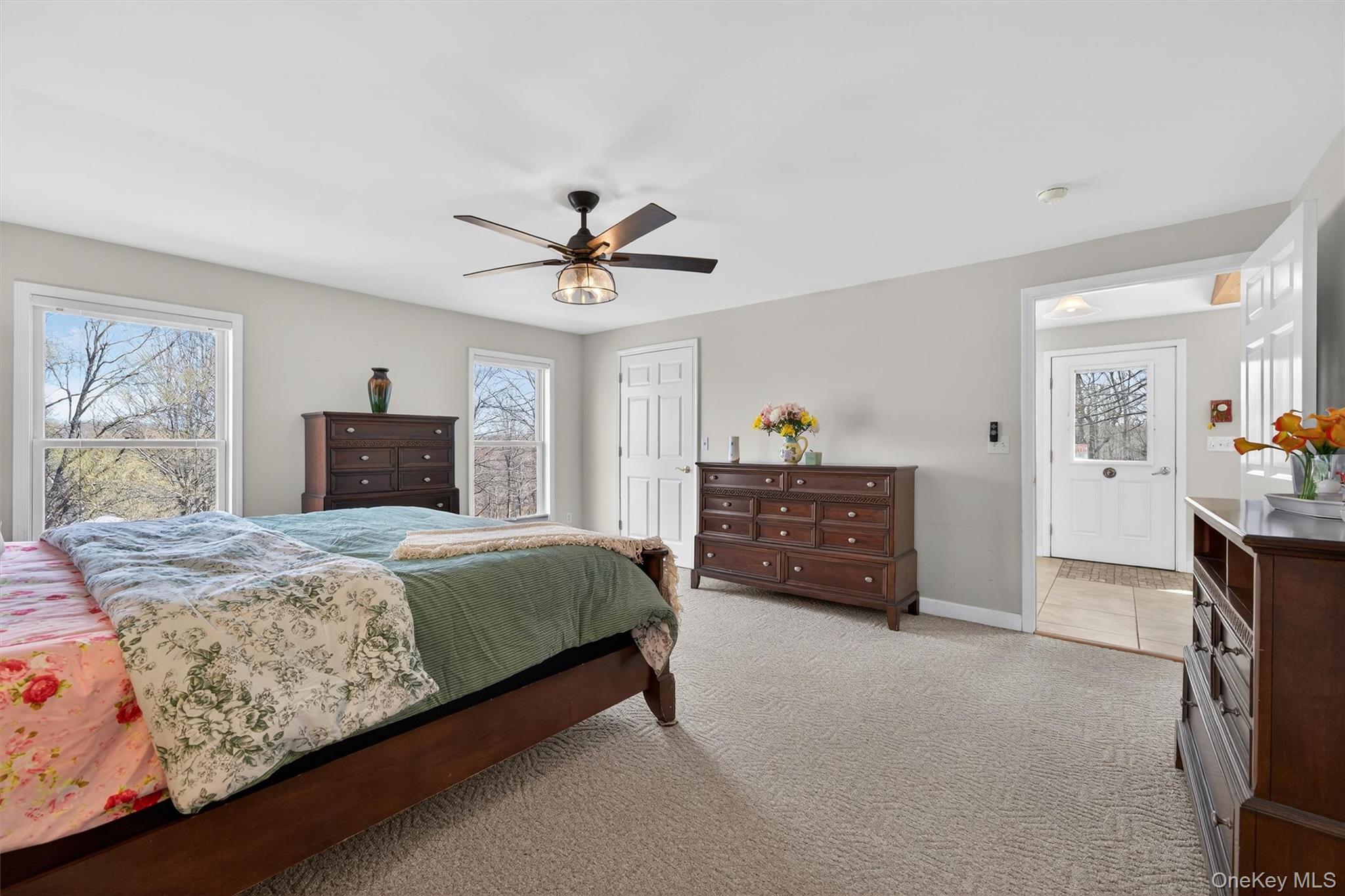 729 Mullock Road Port Jervis, NY 12771 - Photo 17 of 50 a spacious bedroom with a bed a dresser and a window