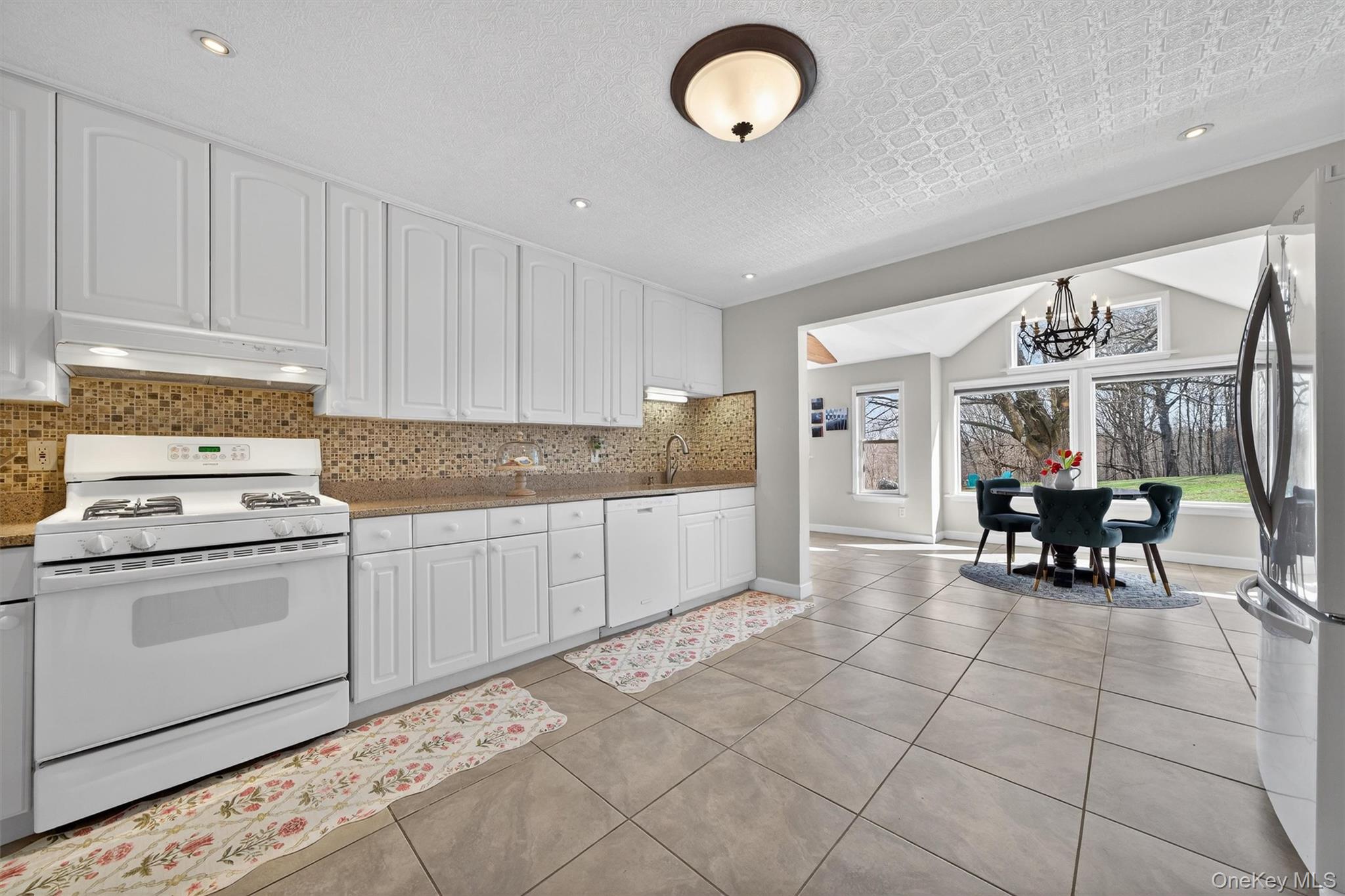 729 Mullock Road Port Jervis, NY 12771 - Photo 22 of 50 a kitchen with granite countertop cabinets and stove top oven