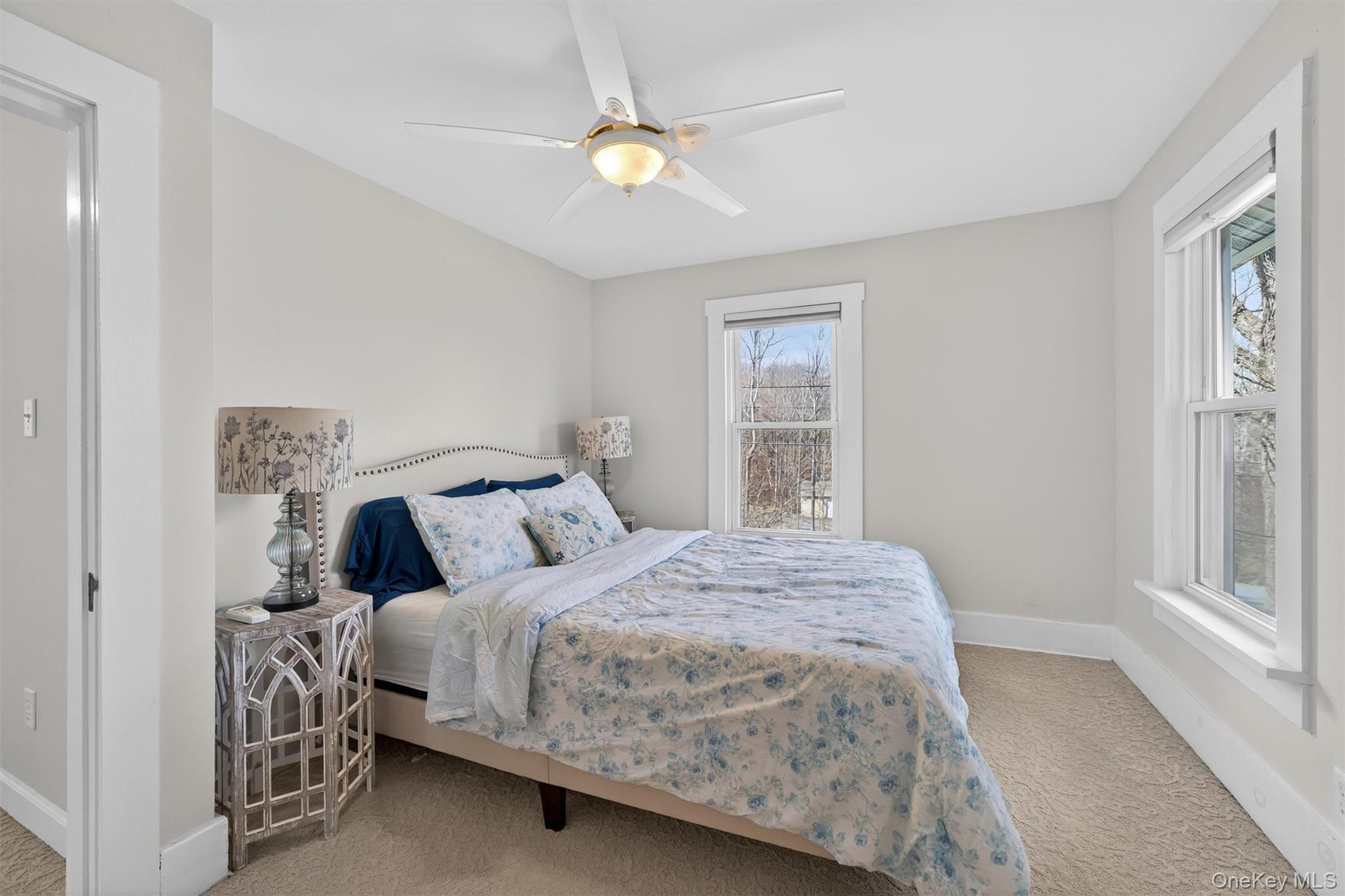 729 Mullock Road Port Jervis, NY 12771 - Photo 34 of 50 a bedroom with a bed and a chandelier