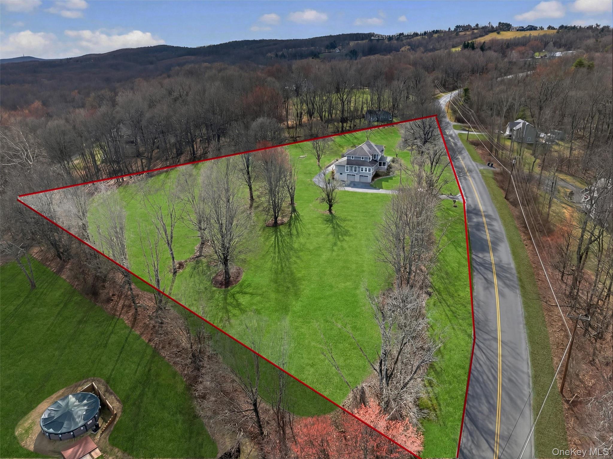 729 Mullock Road Port Jervis, NY 12771 - Photo 48 of 50 a view of a lake with a yard and large trees