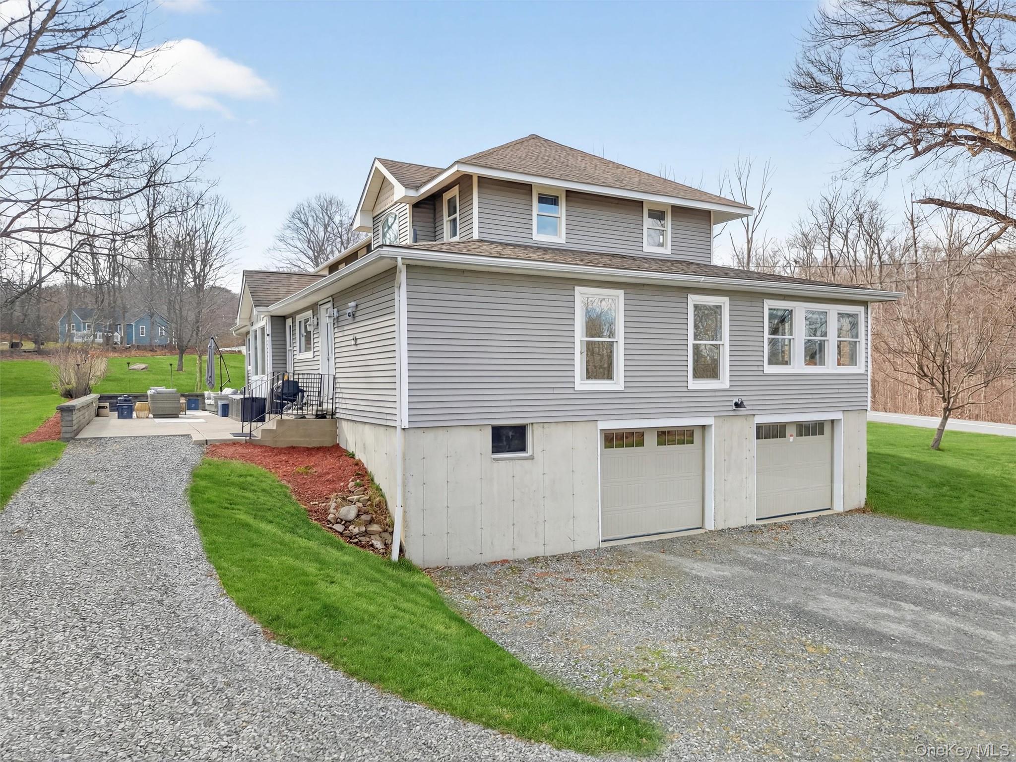 729 Mullock Road Port Jervis, NY 12771 - Photo 5 of 50 a front view of a house with a yard and garage