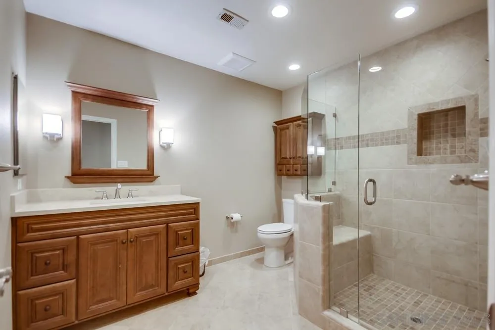 3797 Fallon Circle San Diego, CA 92130 - Photo 18 of 37 a bathroom with a toilet a sink and mirror