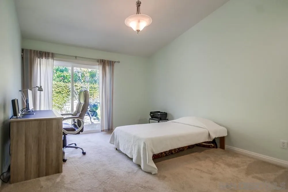 3797 Fallon Circle San Diego, CA 92130 - Photo 19 of 37 a bedroom with a bed and a table