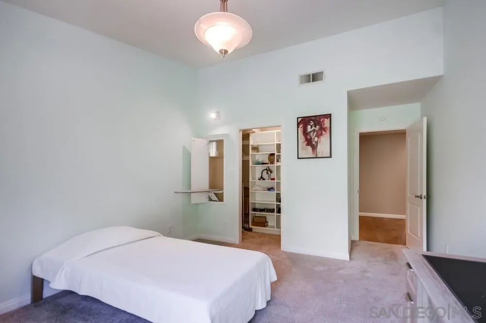 3797 Fallon Circle San Diego, CA 92130 - Photo 20 of 37 a spacious bedroom with a bed and a table in it