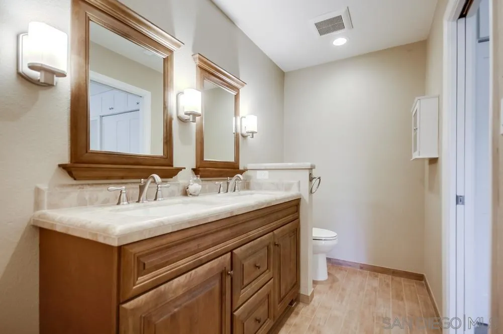 3797 Fallon Circle San Diego, CA 92130 - Photo 25 of 37 a bathroom with a sink and a mirror