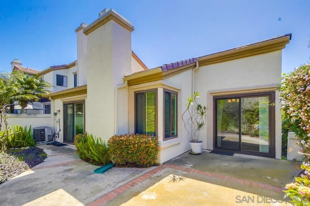 3797 Fallon Circle San Diego, CA 92130 - Photo 28 of 37 a view of a house with brick walls plants and large tree